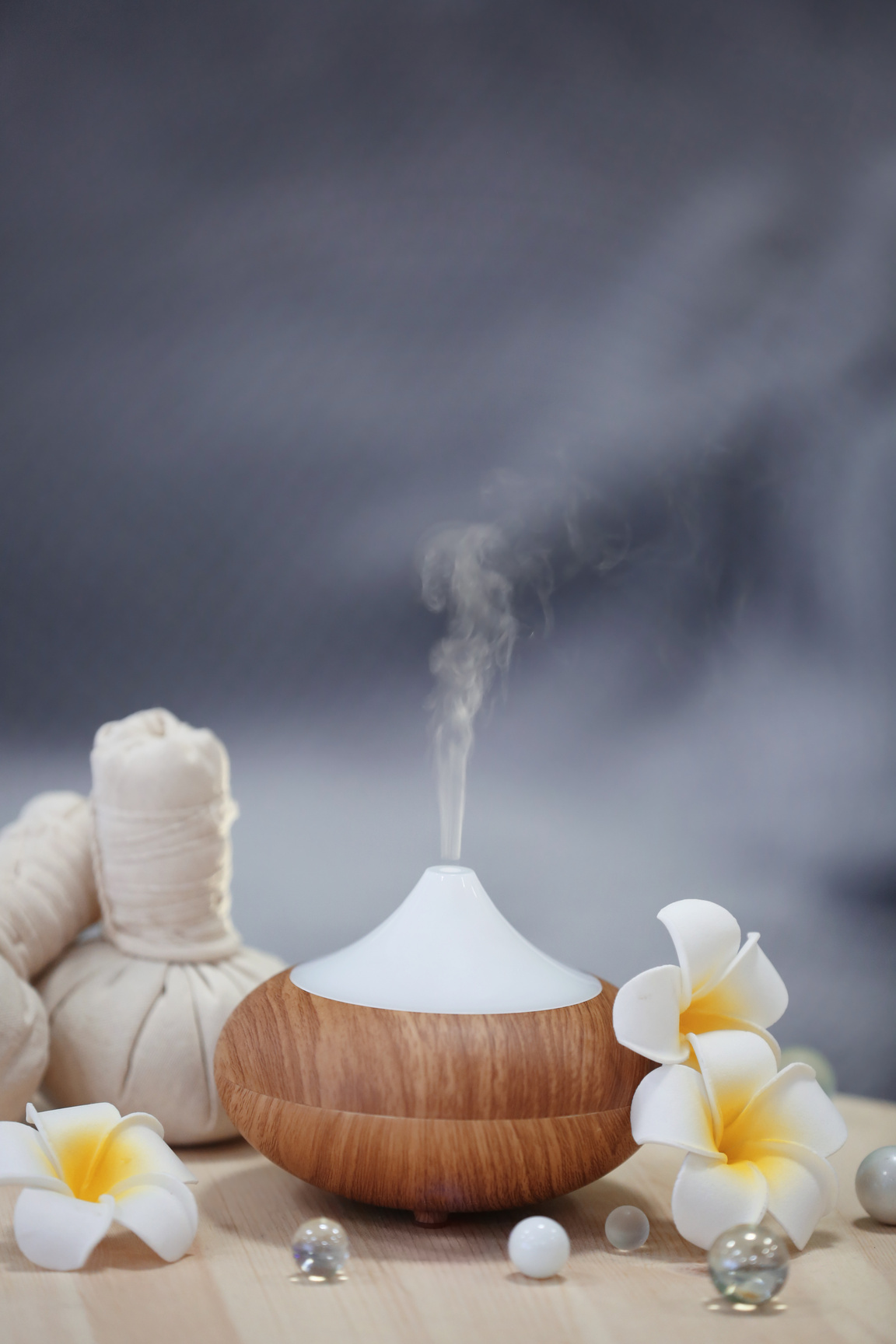 Aroma Oil Diffuser on Table against Blurred Background